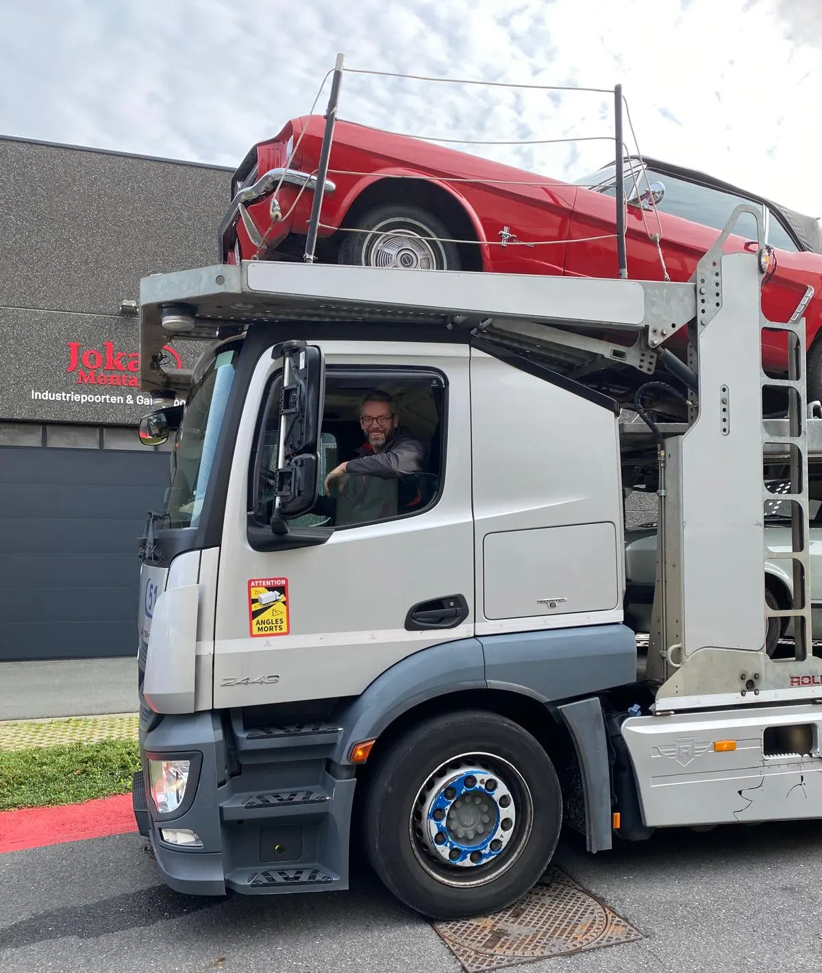 Chauffeur au volant du camion ouvert, classique rouge au pont supérieur